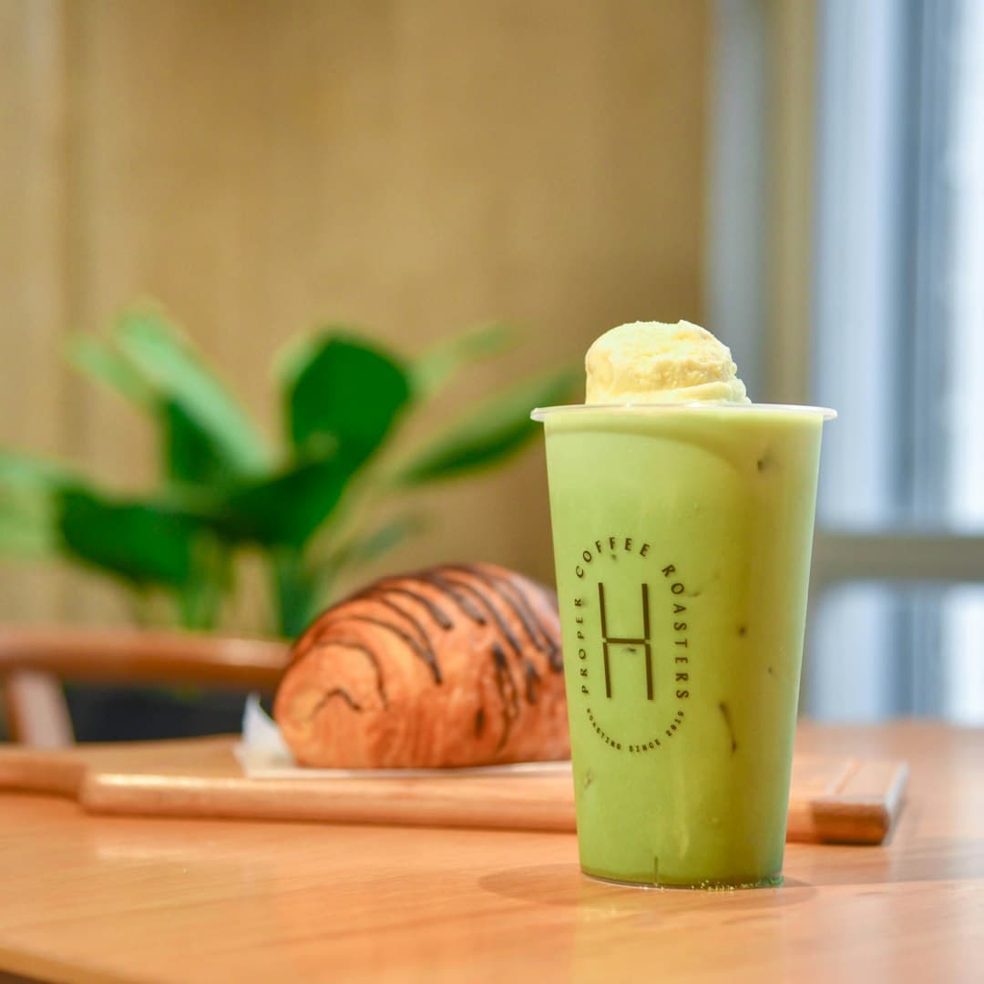 A whisked green matcha on the bar.